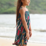 little girl wearing a knee length dress with tie spaghetti straps in dark teal with shell and lei print