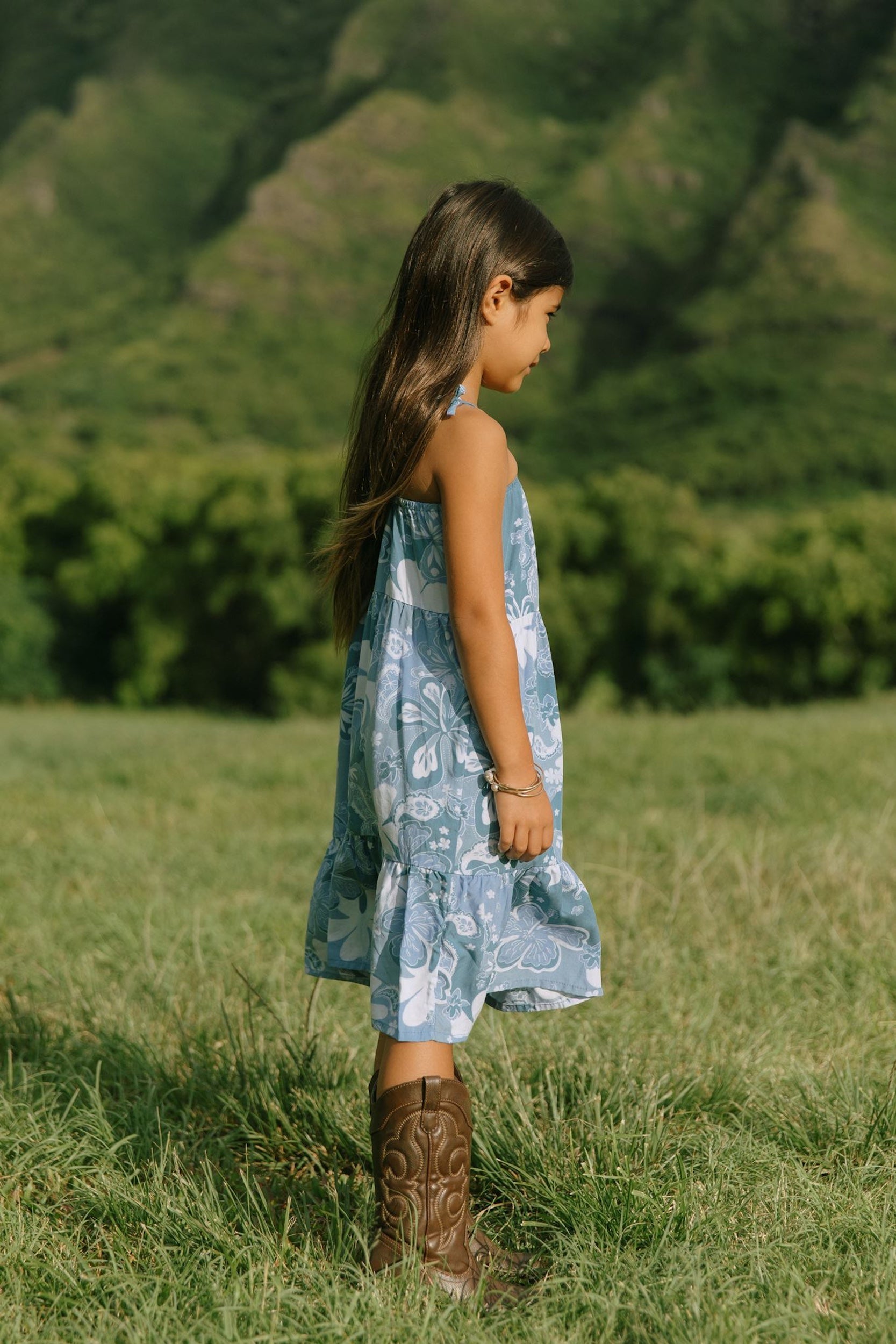 little girl wearing blue paniolo paisley printed dress with tie straps