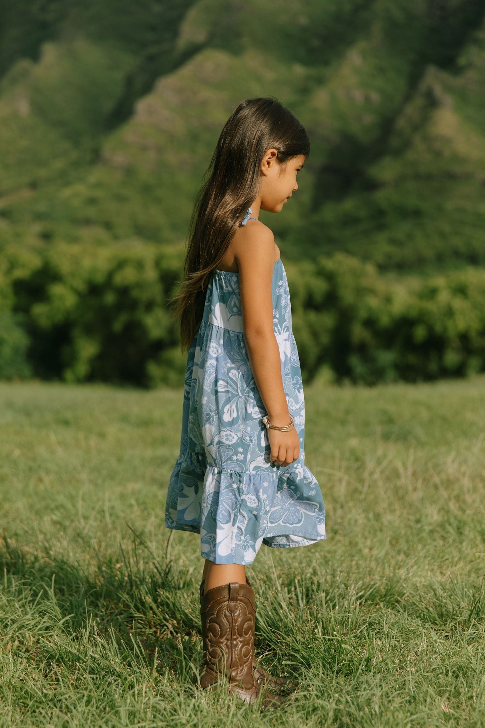 little girl wearing blue paniolo paisley printed dress with tie straps
