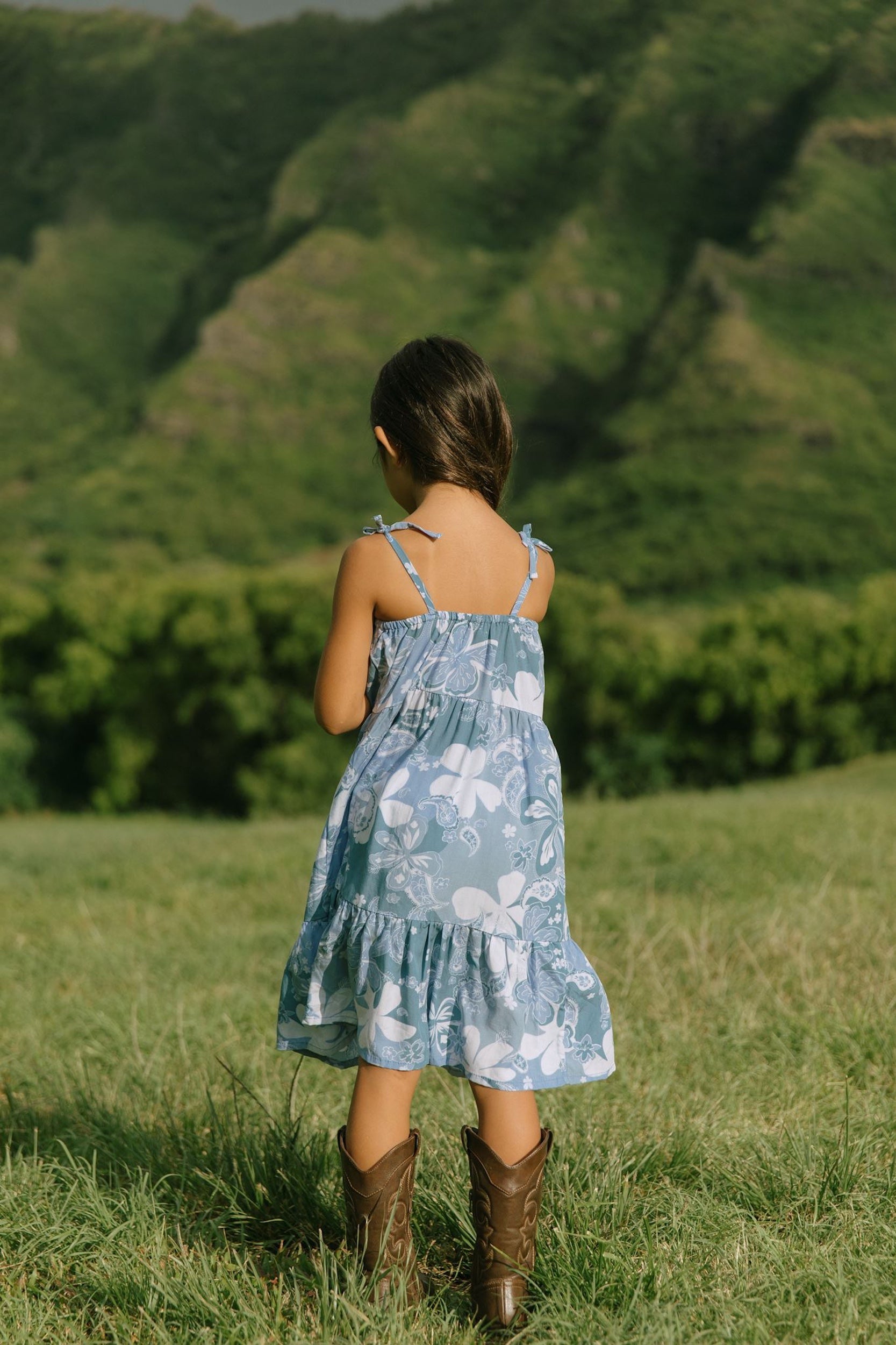 little girl wearing blue paniolo paisley printed dress with tie straps
