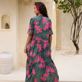 woman with brown hair wearing a dark green half sleeve, oversized maxi dress with button closure, with fern and ginger print