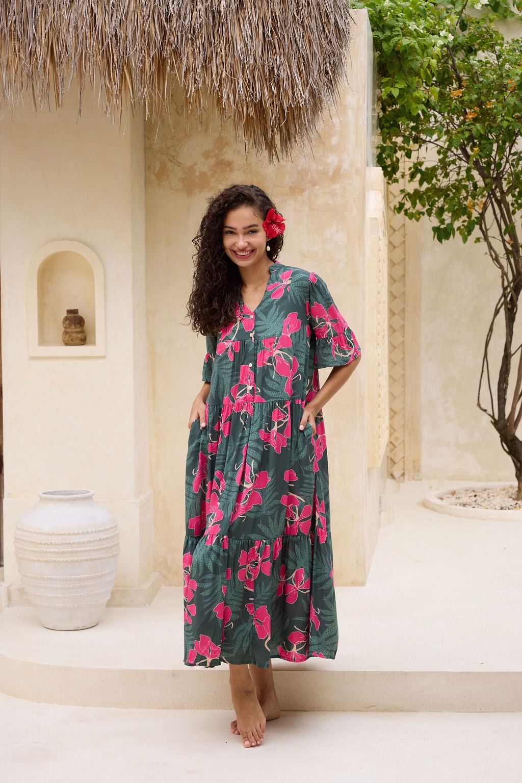 woman with brown hair wearing a dark green half sleeve, oversized maxi dress with button closure, with fern and ginger print