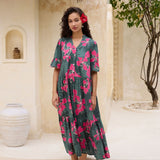 woman with brown hair wearing a dark green half sleeve, oversized maxi dress with button closure, with fern and ginger print