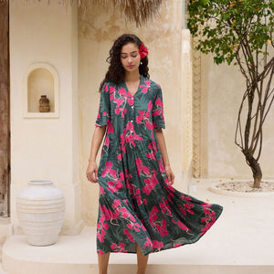 woman with brown hair wearing a dark green half sleeve, oversized maxi dress with button closure, with fern and ginger print