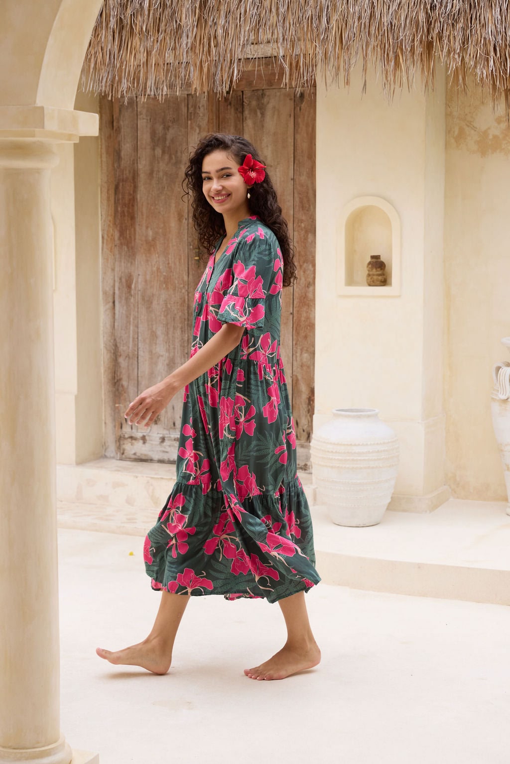 woman with brown hair wearing a dark green half sleeve, oversized maxi dress with button closure, with fern and ginger print