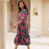 woman with brown hair wearing a dark green half sleeve, oversized maxi dress with button closure, with fern and ginger print