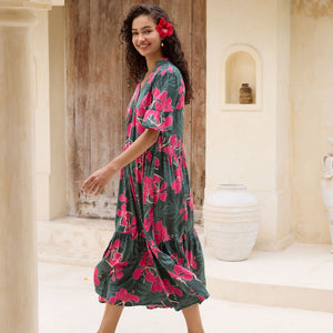 woman with brown hair wearing a dark green half sleeve, oversized maxi dress with button closure, with fern and ginger print