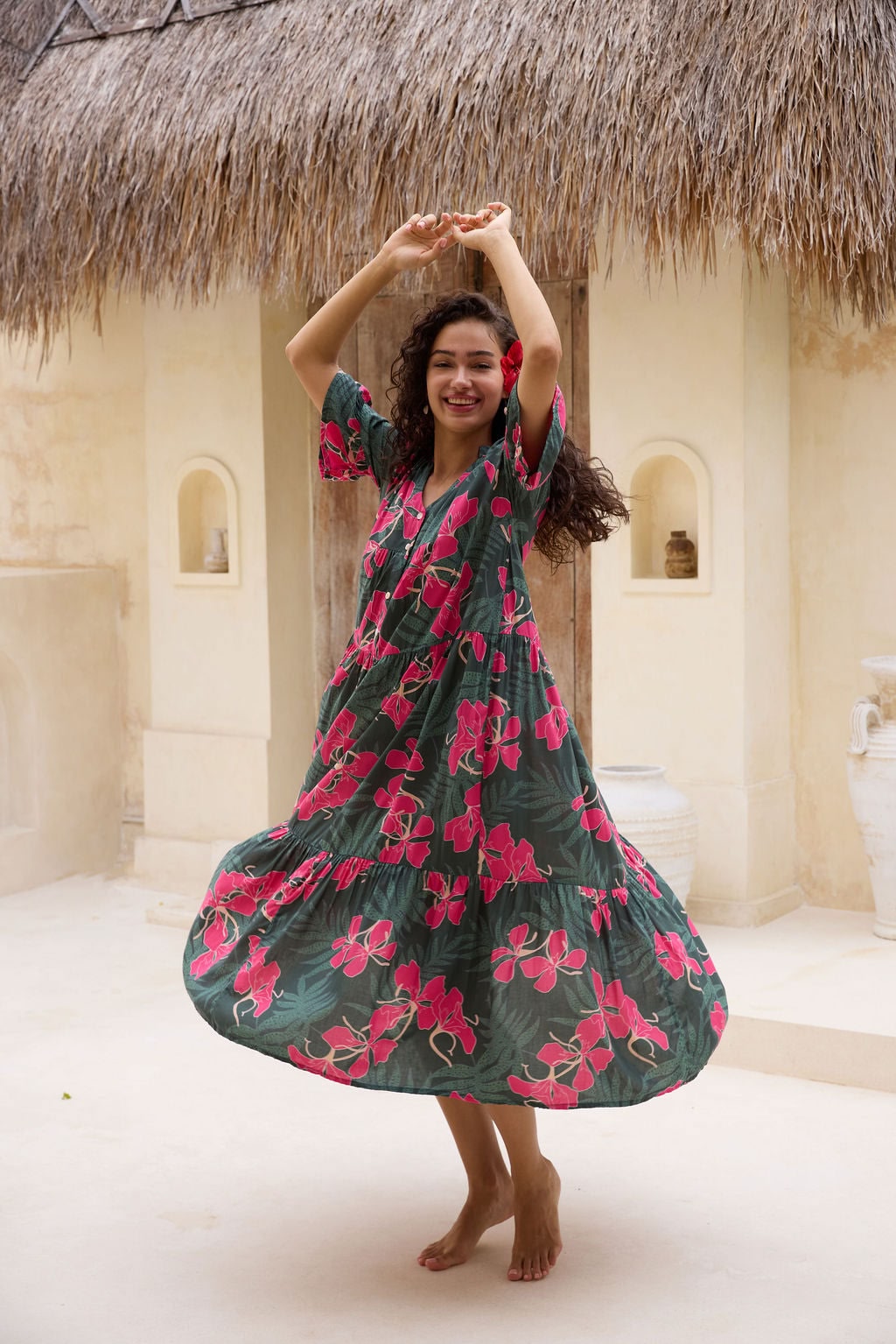 woman with brown hair wearing a dark green half sleeve, oversized maxi dress with button closure, with fern and ginger print