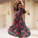 woman with brown hair wearing a dark green half sleeve, oversized maxi dress with button closure, with fern and ginger print