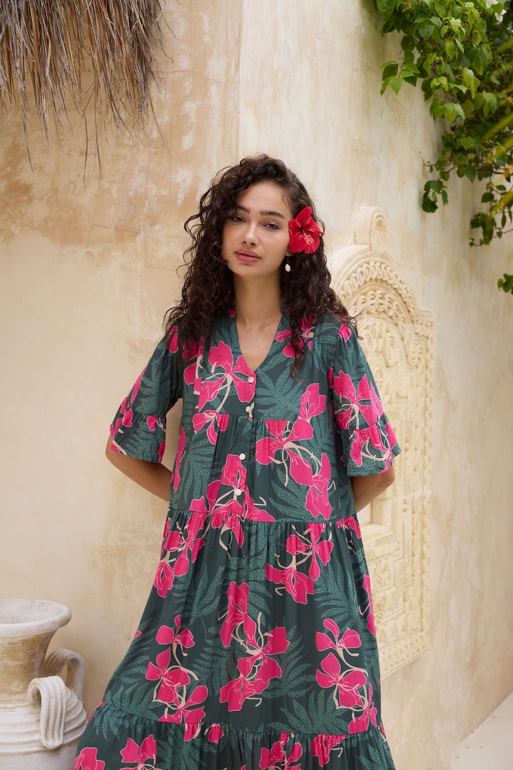 woman with brown hair wearing a dark green half sleeve, oversized maxi dress with button closure, with fern and ginger print