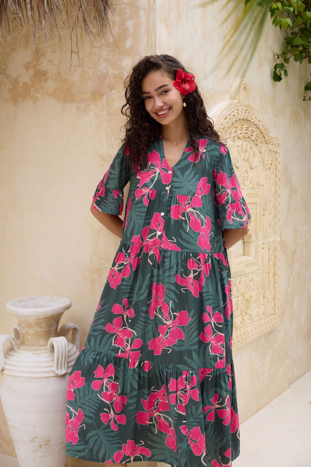 woman with brown hair wearing a dark green half sleeve, oversized maxi dress with button closure, with fern and ginger print