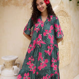 woman with brown hair wearing a dark green half sleeve, oversized maxi dress with button closure, with fern and ginger print