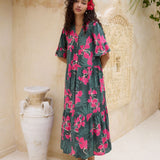 woman with brown hair wearing a dark green half sleeve, oversized maxi dress with button closure, with fern and ginger print