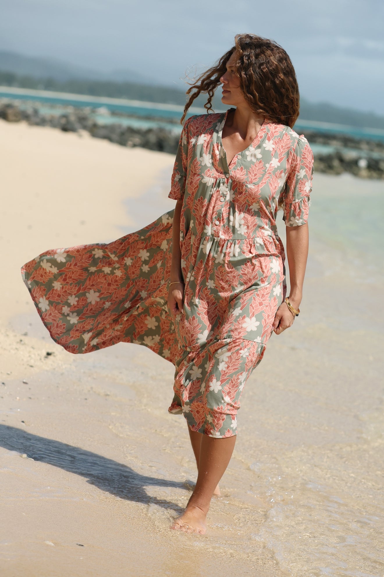 woman with brown hair wearing jade color maxi half sleeve dress with tiare ginger print