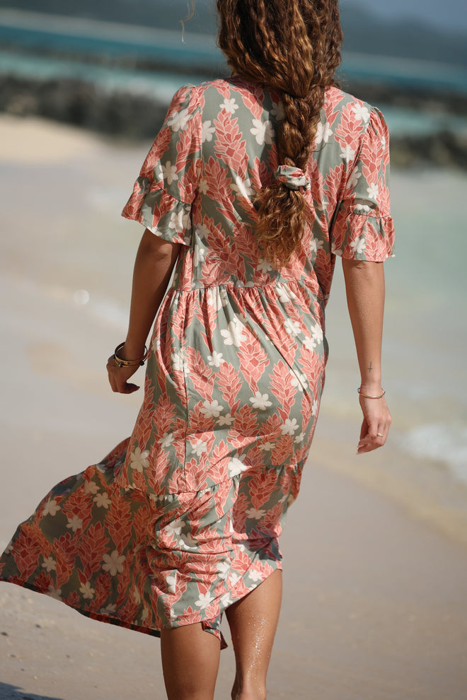 woman with brown hair wearing jade color maxi half sleeve dress with tiare ginger print