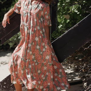 woman with brown hair wearing jade color maxi half sleeve dress with tiare ginger print