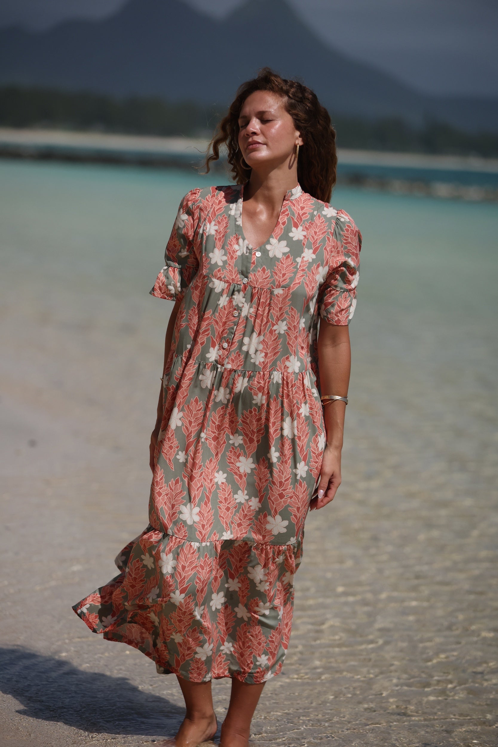 woman with brown hair wearing jade color maxi half sleeve dress with tiare ginger print