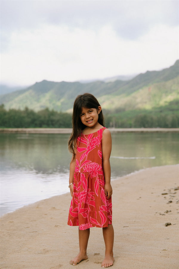 Girl in brown dress with large pink floral print