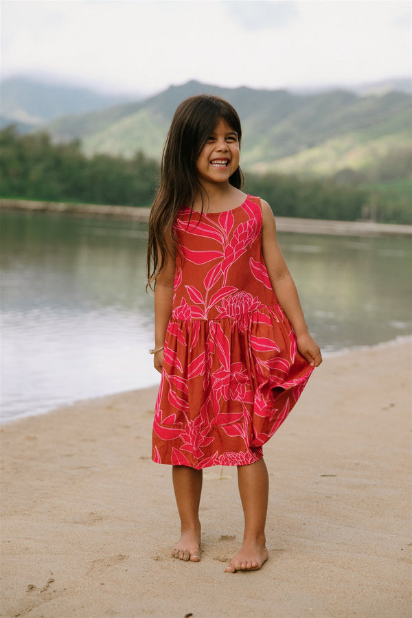 Girl in brown dress with large pink floral print