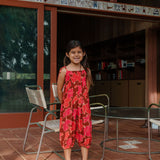 little girl wearing jumpsuit with retro pink pua pattern