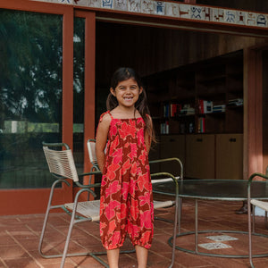 little girl wearing jumpsuit with retro pink pua pattern