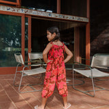 little girl wearing jumpsuit with retro pink pua pattern