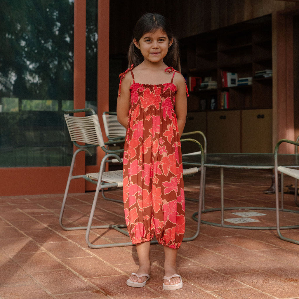 little girl wearing jumpsuit with retro pink pua pattern
