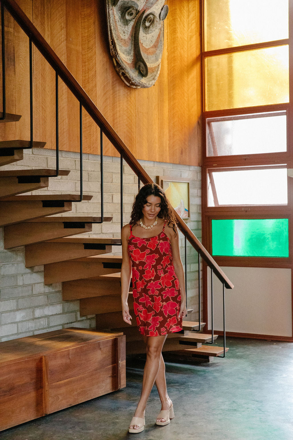 woman with brown hair wearing a spaghetti strap mini slip dress with retro pink pua print
