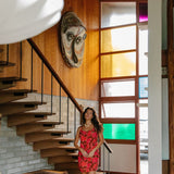 woman with brown hair wearing a spaghetti strap mini slip dress with retro pink pua print