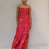 woman with brown hair wearing a spaghetti strap maxi dress with awapuhi print