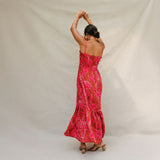 woman with brown hair wearing a spaghetti strap maxi dress with awapuhi print