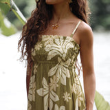woman with brown hair wearing yellow glass plumeria necklace and earrings 
