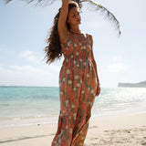 woman with blonde hair wearing jade colored maxi dress with tiare ginger print