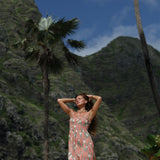 woman with blonde hair wearing jade colored maxi dress with tiare ginger print