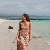woman with blonde hair wearing jade colored maxi dress with tiare ginger print