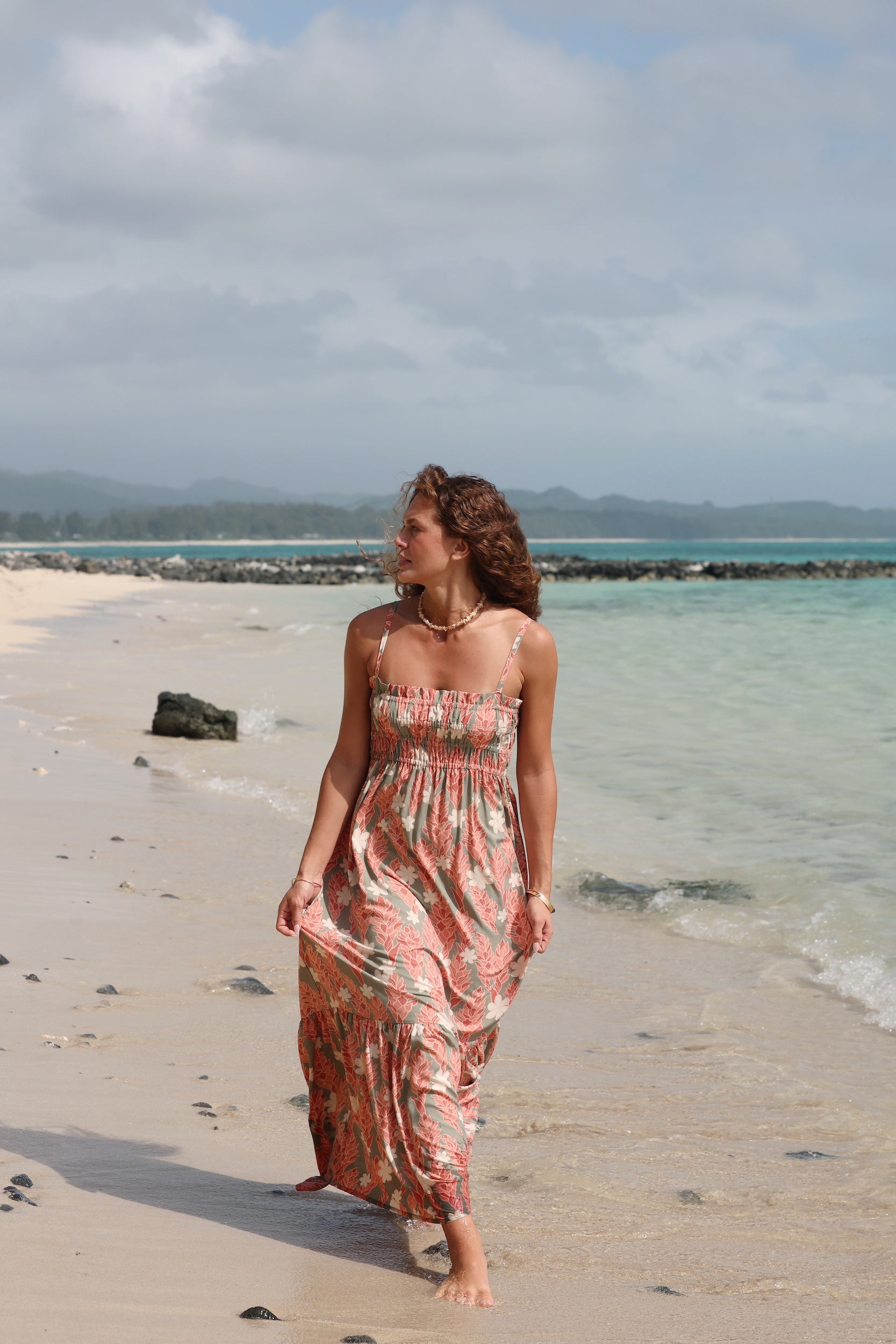 woman with blonde hair wearing jade colored maxi dress with tiare ginger print