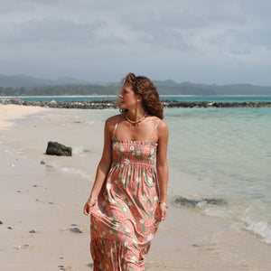 woman with blonde hair wearing jade colored maxi dress with tiare ginger print