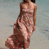 woman with blonde hair wearing jade colored maxi dress with tiare ginger print
