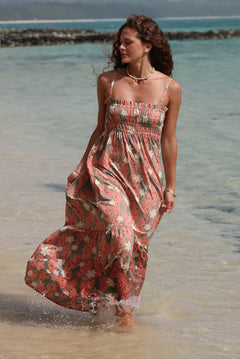 woman with blonde hair wearing jade colored maxi dress with tiare ginger print