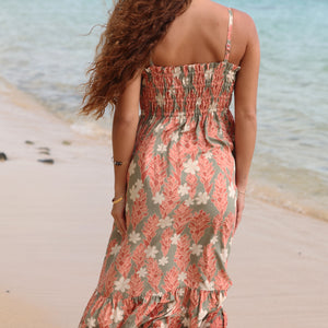 woman with blonde hair wearing jade colored maxi dress with tiare ginger print