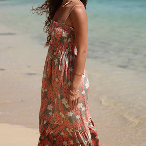 woman with blonde hair wearing jade colored maxi dress with tiare ginger print