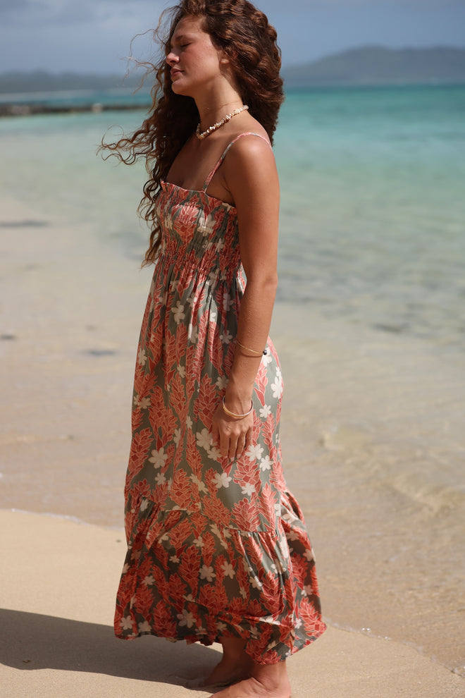 woman with blonde hair wearing jade colored maxi dress with tiare ginger print