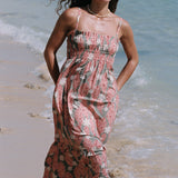 woman with blonde hair wearing jade colored maxi dress with tiare ginger print
