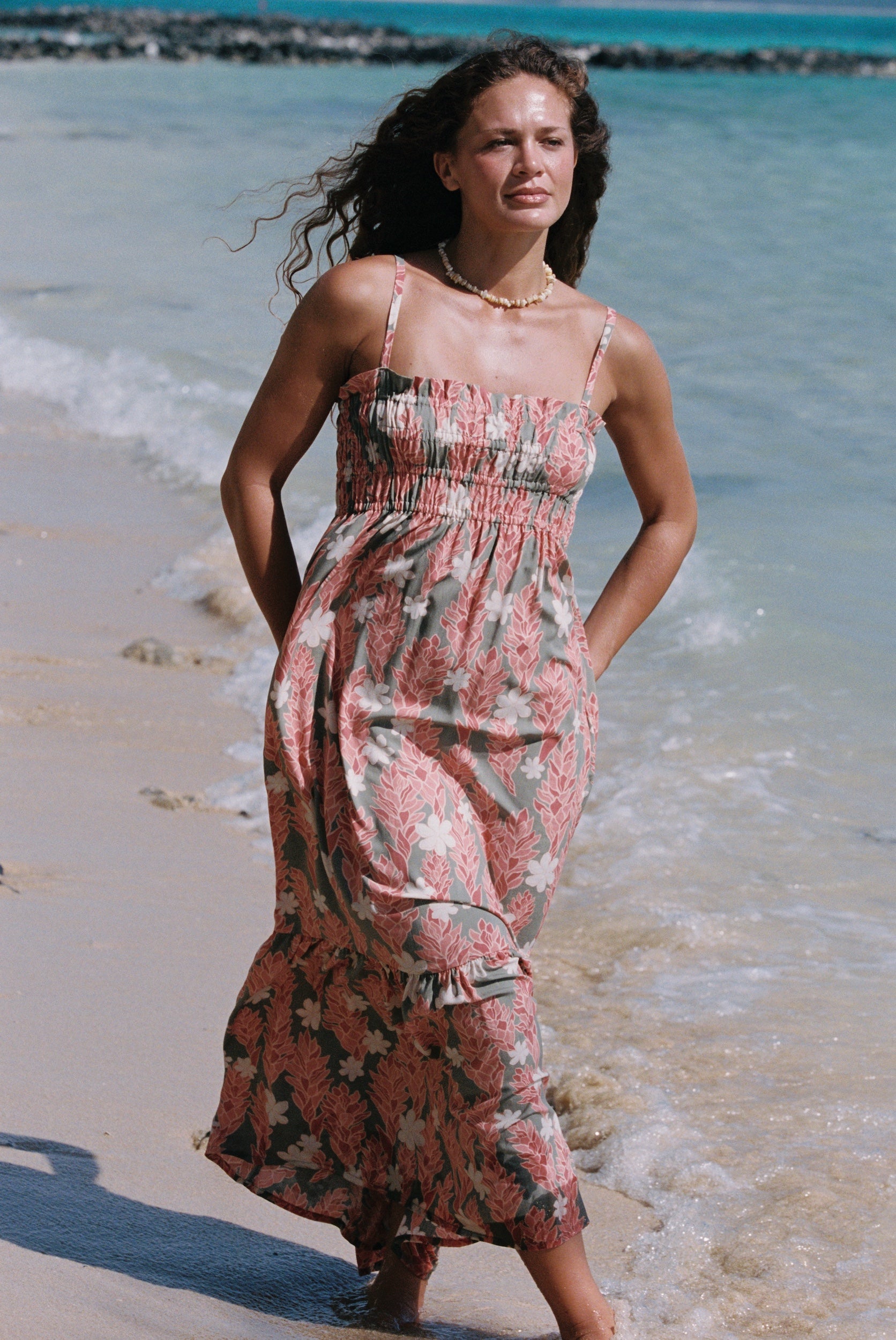 woman with blonde hair wearing jade colored maxi dress with tiare ginger print