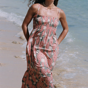 woman with blonde hair wearing jade colored maxi dress with tiare ginger print