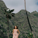woman with blonde hair wearing jade colored maxi dress with tiare ginger print