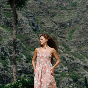 woman with blonde hair wearing jade colored maxi dress with tiare ginger print