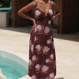woman wearing a brown maxi dress with knot detail and protea print