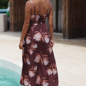 woman wearing a brown maxi dress with knot detail and protea print