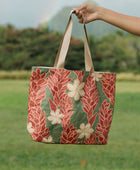 Woman with tote bag with red ginger flowers and beige tiare flower print.